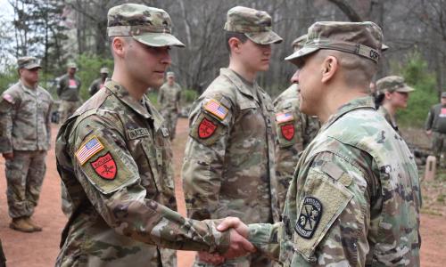 LTC Cortez shaking hands with a newly contracted cadet
